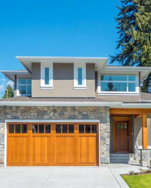 A beautiful residence with a spacious garage and a neatly paved driveway, enhancing its curb appeal.